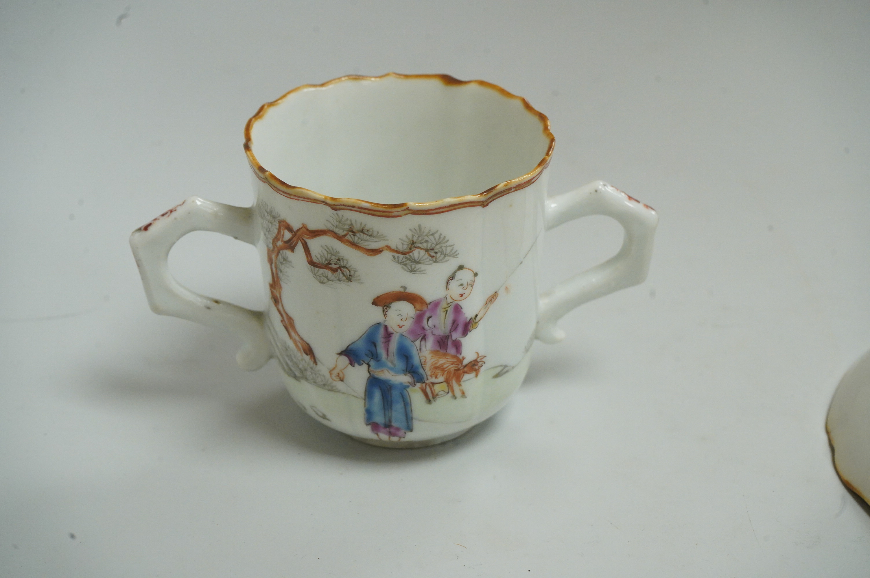 A Chinese export famille rose chocolate cup and trembleuse saucer, Qianlong period, saucer 13cm in diameter